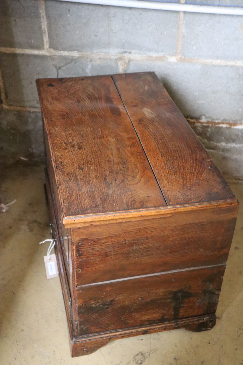 A 19th century oak coffer bach, having detachable planked top over panel front and drawer, width 67cm depth 47cm height 46cm